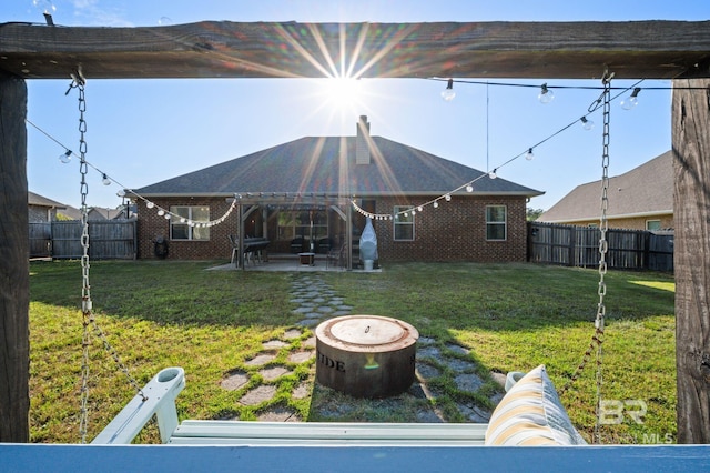 back of property featuring brick siding, a fenced backyard, and a patio