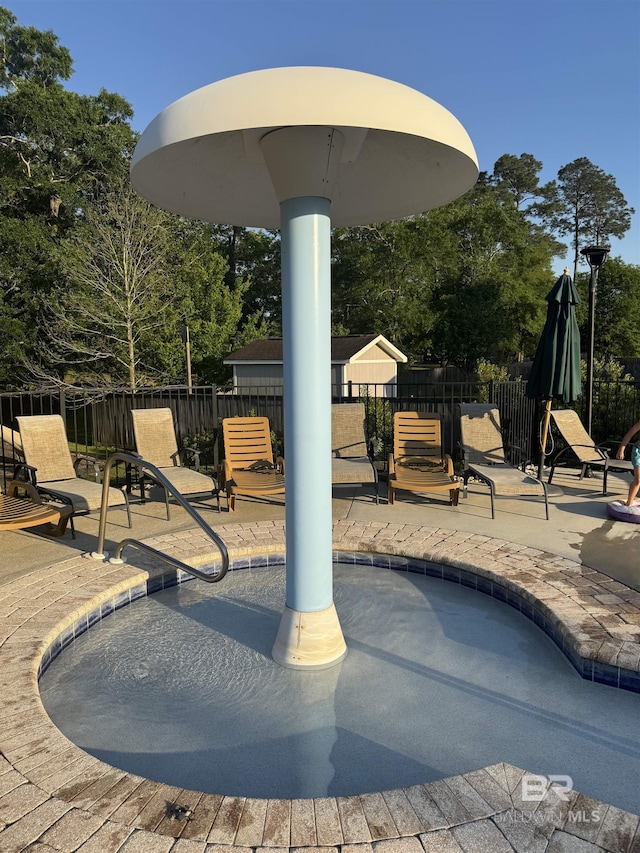 pool with fence and a patio