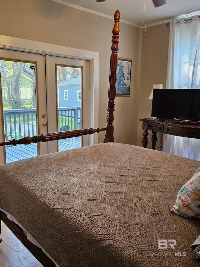 bedroom with access to outside and ornamental molding