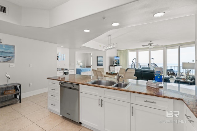 kitchen with ceiling fan, dishwasher, sink, light tile patterned floors, and white cabinets