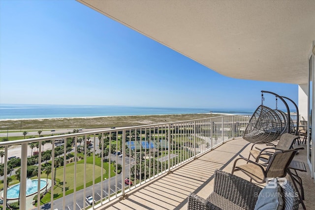 balcony featuring a water view and a view of the beach