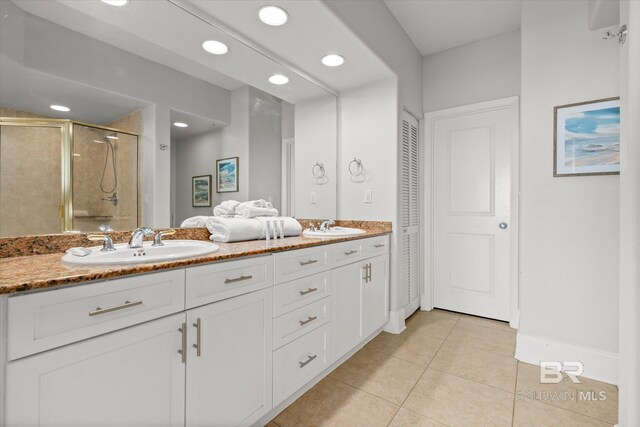 bathroom featuring tile patterned floors, vanity, and walk in shower