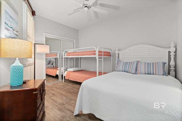 bedroom featuring hardwood / wood-style flooring, ceiling fan, and a closet