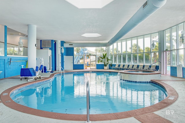 view of swimming pool with an indoor hot tub