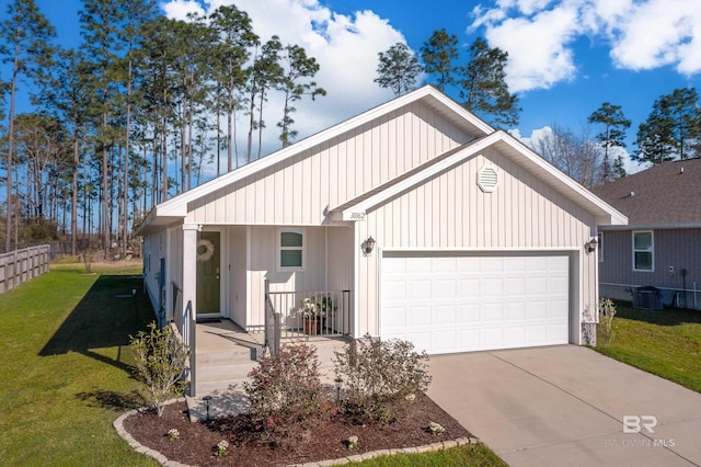 view of front facade with an attached garage, concrete driveway, and a front lawn