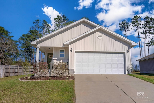 view of front of home featuring concrete driveway, an attached garage, fence, and a front lawn