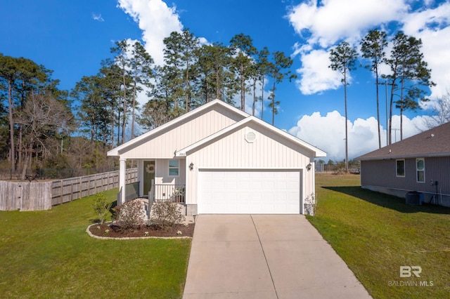 view of front of home featuring concrete driveway, an attached garage, fence, and a front lawn