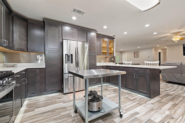 1101 Alabama Ave, Dauphin Island, AL 36528 - kitchen with appliances with stainless steel finishes, a peninsula, light countertops, open floor plan, and recessed lighting