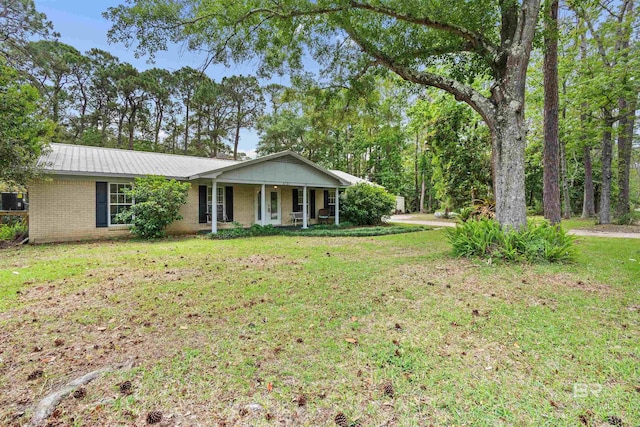 1101 Alabama Ave, Dauphin Island, AL 36528 - single story home featuring a porch, a front yard, and brick siding