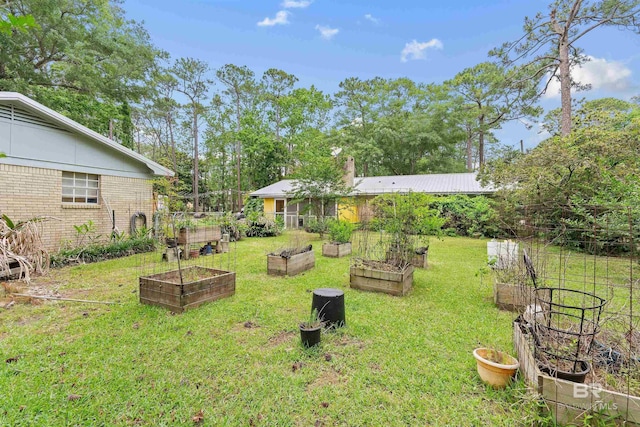 1101 Alabama Ave, Dauphin Island, AL 36528 - view of grassy yard featuring a vegetable garden