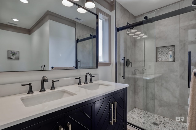 bathroom featuring vanity and an enclosed shower