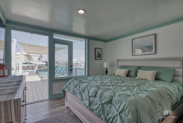 bedroom featuring access to exterior, crown molding, and light hardwood / wood-style flooring