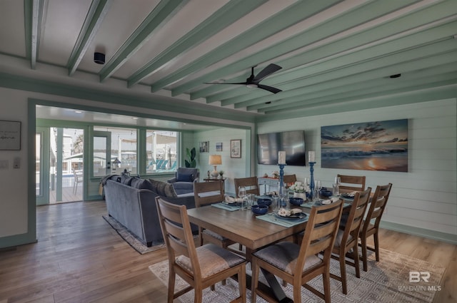 dining area with ceiling fan, beam ceiling, and light hardwood / wood-style floors