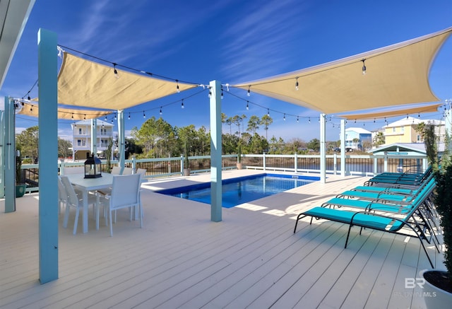 view of swimming pool with a deck