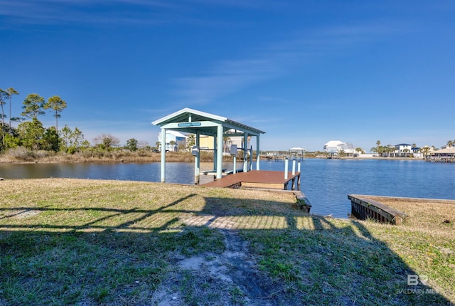 dock area with a water view and a yard