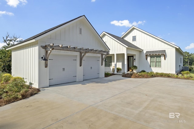 modern inspired farmhouse with a garage and central air condition unit