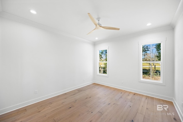 spare room with light hardwood / wood-style floors, plenty of natural light, ornamental molding, and ceiling fan