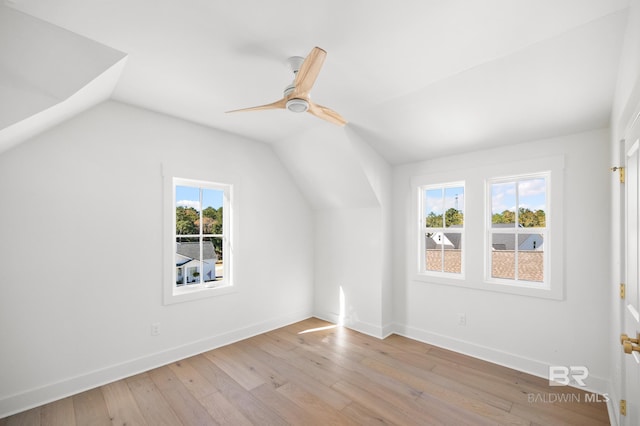 additional living space featuring light hardwood / wood-style floors, a wealth of natural light, lofted ceiling, and ceiling fan