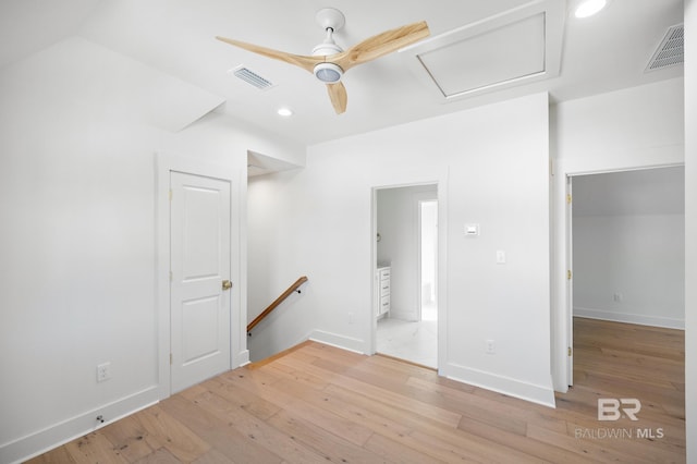 empty room with ceiling fan and light hardwood / wood-style floors