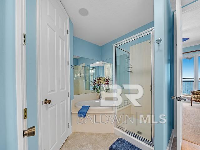 bathroom featuring tile floors, walk in shower, and french doors