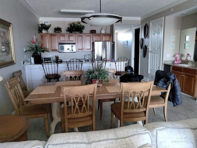 dining room featuring crown molding and sink