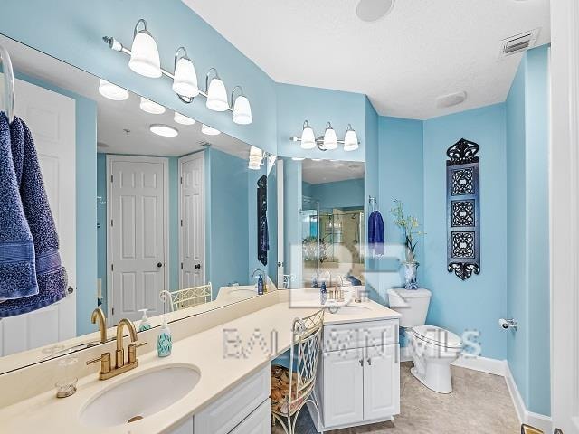 bathroom with tile flooring, toilet, and double vanity