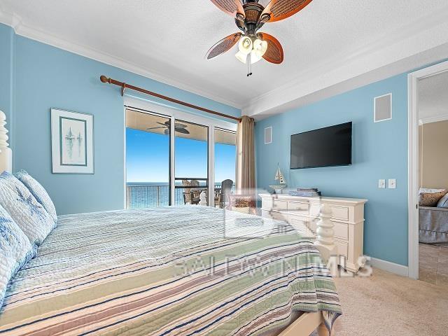 carpeted bedroom with ceiling fan, access to exterior, and ornamental molding