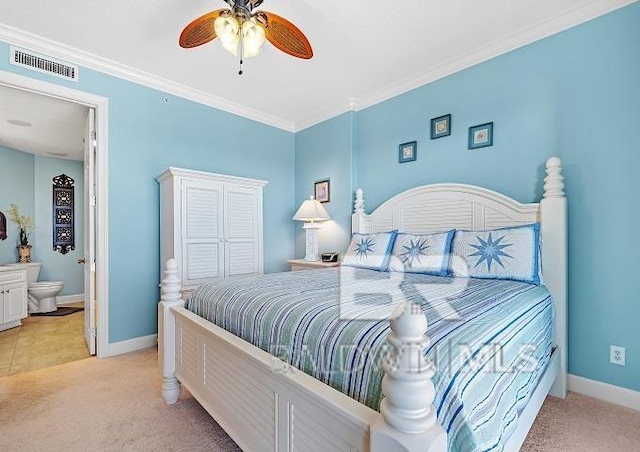 bedroom with ensuite bath, ornamental molding, light colored carpet, and ceiling fan