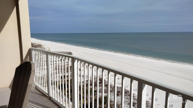 balcony featuring a water view and a view of the beach