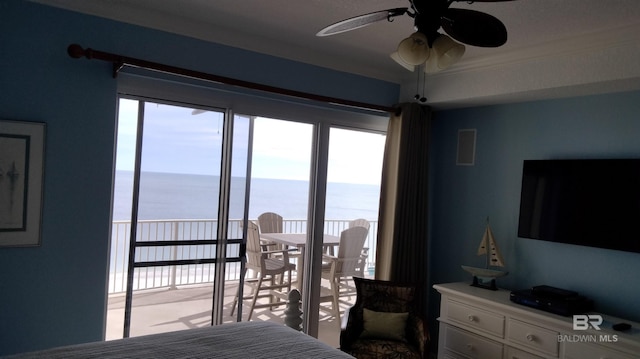 bedroom featuring ceiling fan and a water view