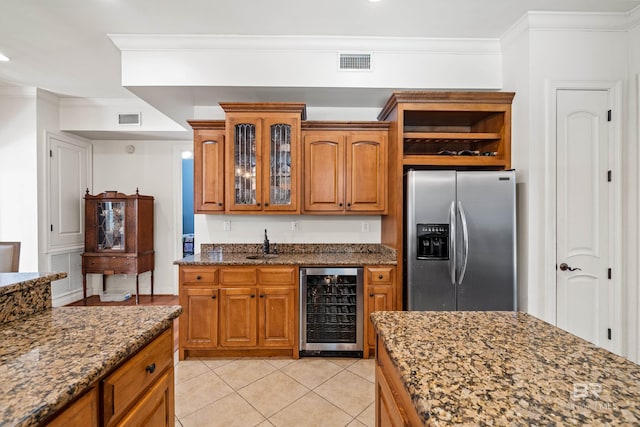 kitchen with stone counters, sink, wine cooler, stainless steel refrigerator with ice dispenser, and crown molding