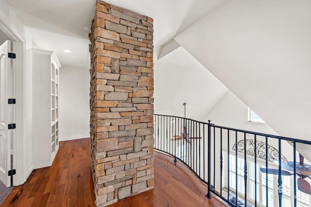 hall with dark wood-type flooring and lofted ceiling