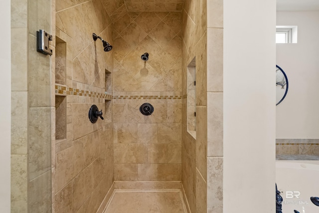 bathroom with a tile shower