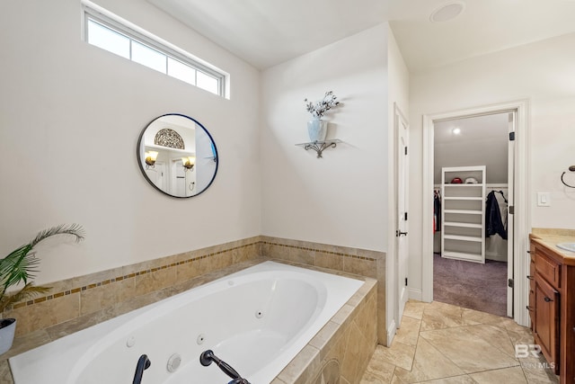 bathroom featuring vanity and a relaxing tiled tub