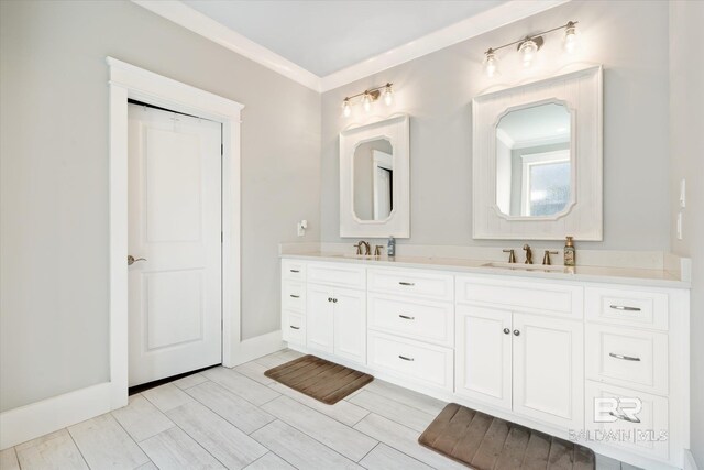 bathroom with crown molding and vanity