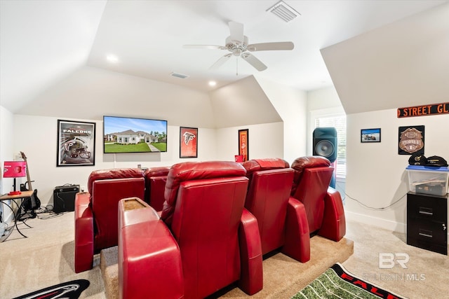 carpeted cinema room with ceiling fan and lofted ceiling