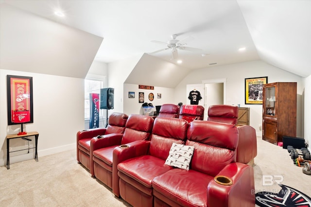 home theater featuring ceiling fan, light colored carpet, and vaulted ceiling