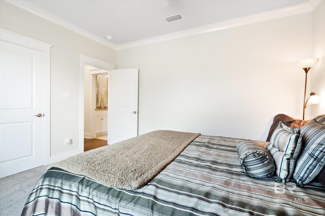 carpeted bedroom with ornamental molding