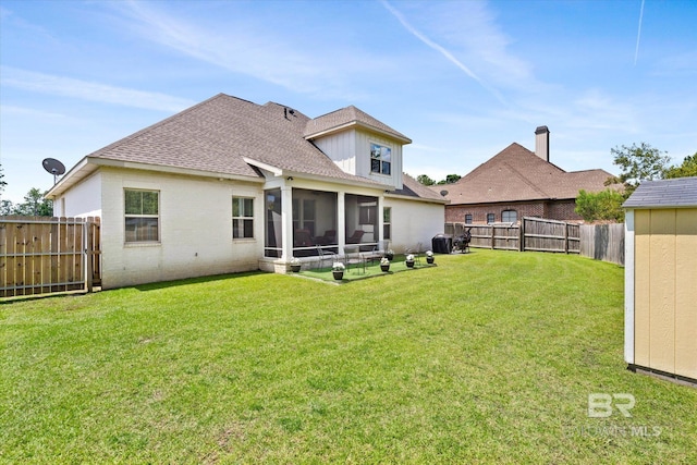 rear view of house with a lawn and a sunroom