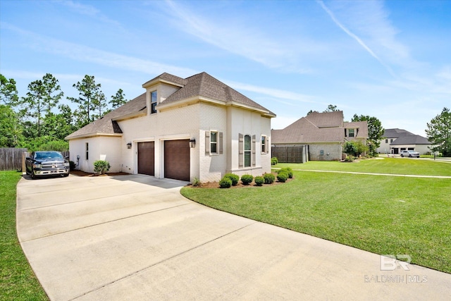 view of front of house featuring a front yard and a garage