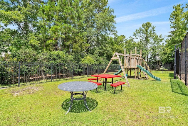 view of playground with a lawn