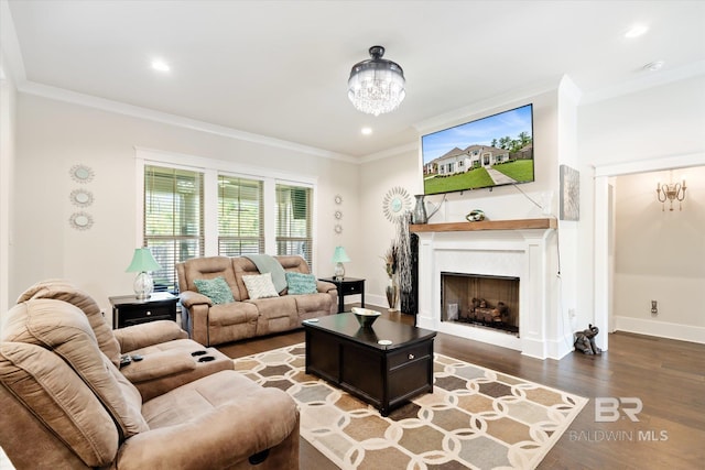 living room featuring a chandelier, wood-type flooring, and ornamental molding