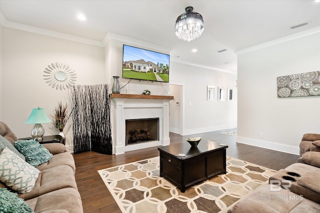 living room with hardwood / wood-style flooring, a notable chandelier, and crown molding