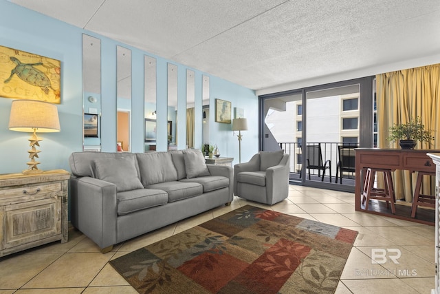 tiled living room featuring a textured ceiling