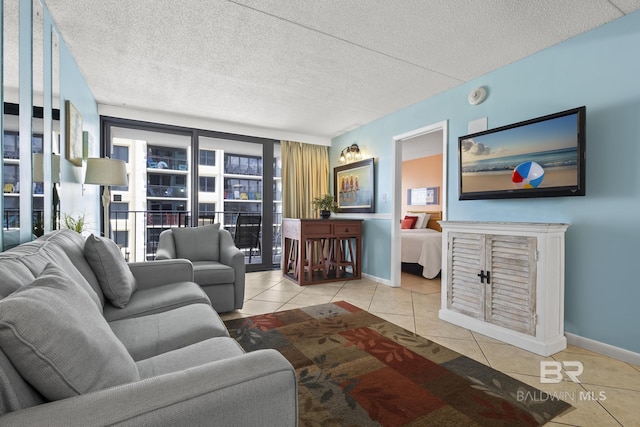 tiled living room featuring a textured ceiling