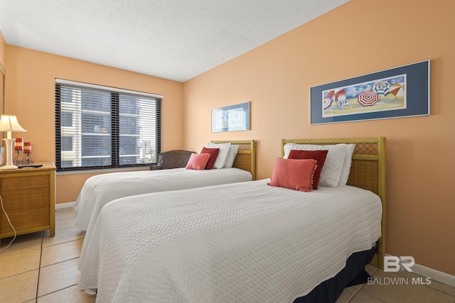 bedroom with light tile patterned floors and a textured ceiling