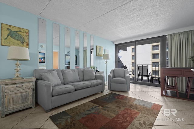 tiled living room with floor to ceiling windows and a textured ceiling