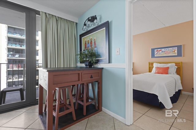 bedroom featuring light tile patterned floors and vaulted ceiling