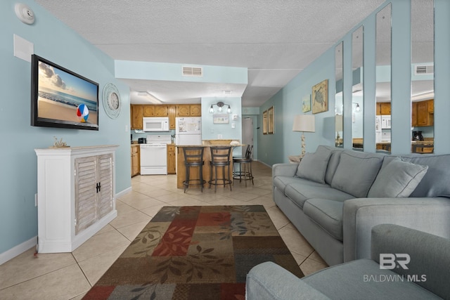 living room featuring light tile patterned floors and a textured ceiling