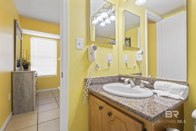 bathroom with tile patterned floors, vanity, and toilet